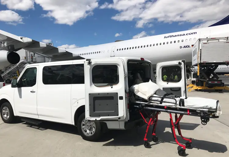 Eastern Royal Medical Transport van with its rear doors open and a transport stretcher ready for loading